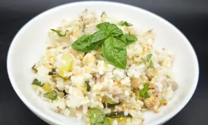 Un plat de riz aux courgettes et thon, garni de basilic frais. Une recette simple et savoureuse.