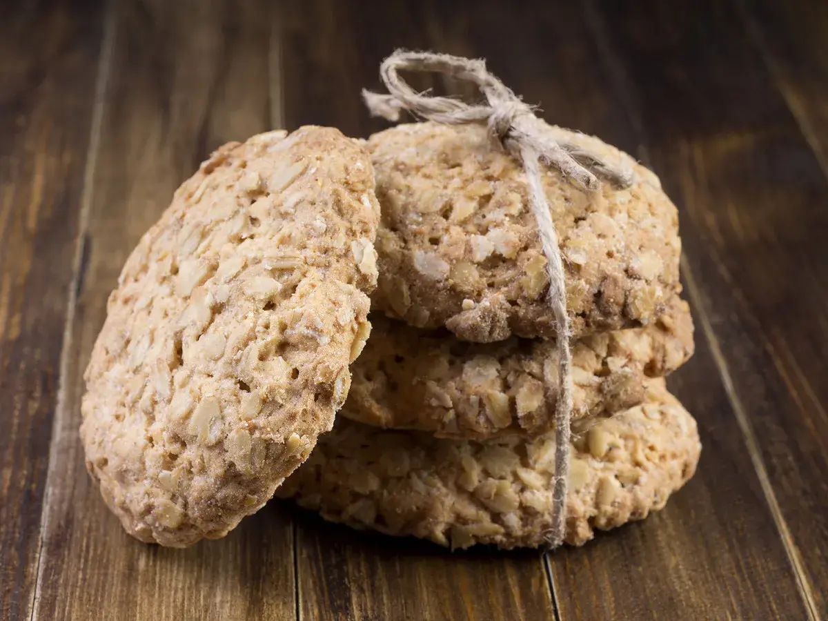 Biscuits aux flocons d'avoine, liés par une ficelle, sur fond de bois. Parfait pour une recette flocon d'avoine maison.
