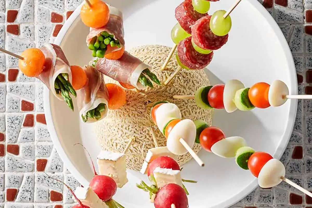 Brochettes ap&eacute;ro color&eacute;es : asperges enroul&eacute;es de jambon, melon, tomates, concombres, &oelig;ufs, radis et fromage. Un r&eacute;gal visuel !
