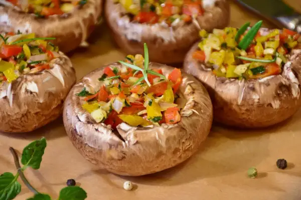 Champignons farcis aux poivrons colorés et herbes fraîches, prêts à être dégustés.